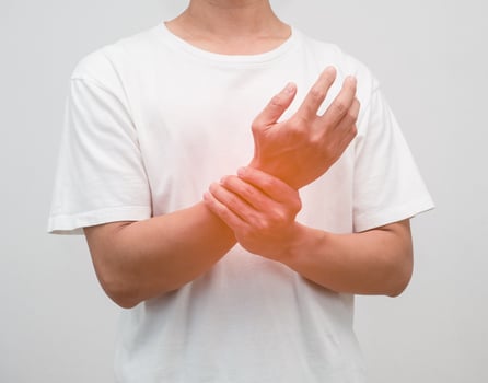 Close up male hand hurt his wrist studio shot photo