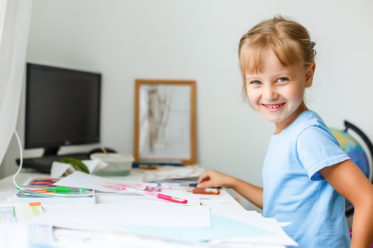 education, creation and school concept - smiling little student girl drawing and daydreaming at school photo