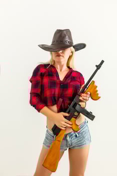 The sexy blonde woman with a hat woman cowboy on a white background photo