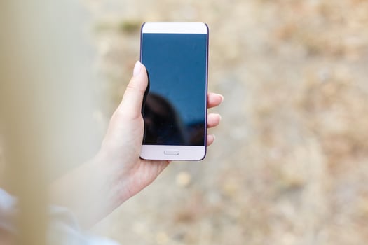 Smiling woman with a smartphone photo