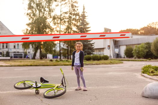 little girl on a bicycle bike near the barrier photo