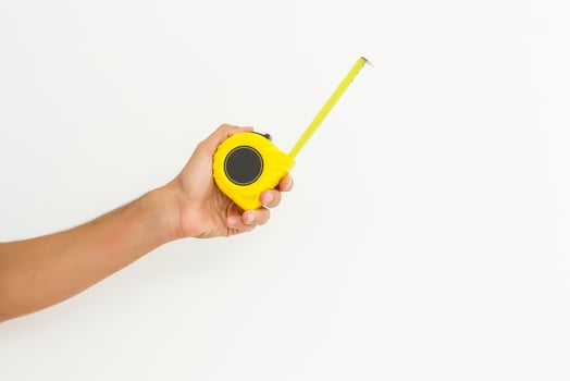 human hand with tape-measure isolated on white photo