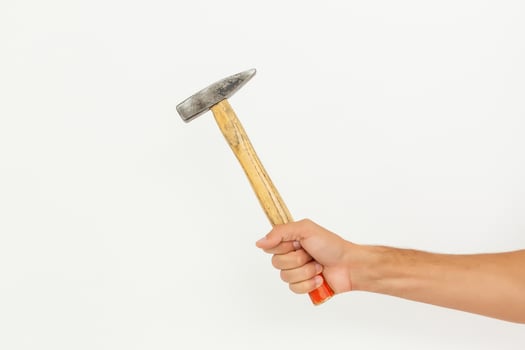 Hand with hammer. Isolated on white background. photo
