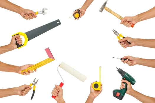 Hands holding hand tools isolated on white background photo