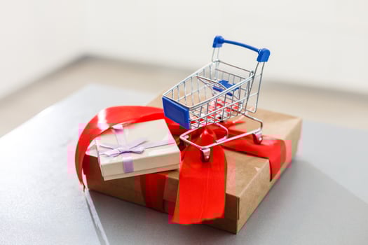 a huge gift with a red ribbon and a shopping cart photo