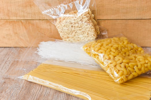 Raw spaghetti italian pasta uncooked - raw Macaroni , instant noodles and Rice Vermicelli in package pasta product dry food , non perishable food photo