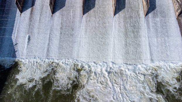 An aerial view over the Pasak Jolasid dam, Lopburi Province, Thailand. Tracking the movement of the floodgates that are releasing water into rural canals in enormous amounts of water. photo