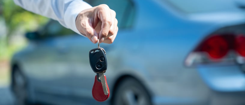 selling car, car sale, deal concept The dealer gives the car keys to the new owner or renter with an insurance contract. banner photo