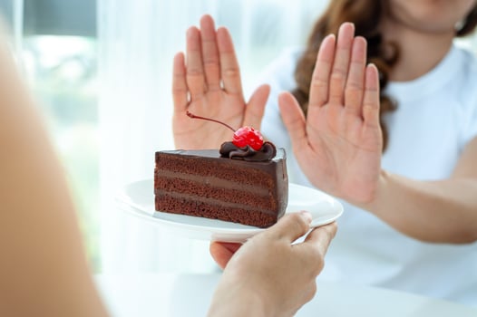 The women used to push the cake plate with the people.  Do not eat desserts for weight loss. photo