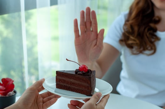 The women used to push the cake plate with the people.  Do not eat desserts for weight loss. photo