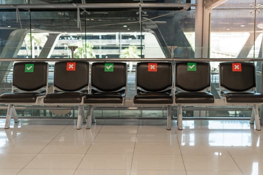 Public chair layouts spaced socially during the Covid-19 situation in the airport terminal. Social distance concept. photo