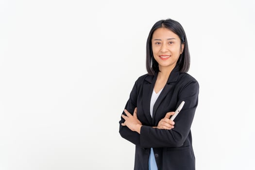 Asian businesswoman smiling and holding smartphone. Beautiful asian woman standing with crossed arms.  female portraits. Bank staff, accountant, administration, officer photo
