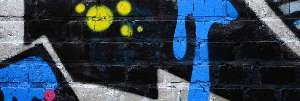 Fragment of graffiti drawings. The old wall decorated with paint stains in the style of street art culture. Colored background texture photo
