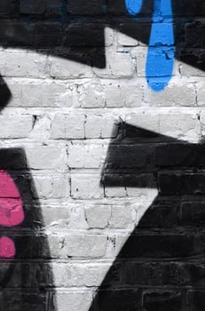 Fragment of graffiti drawings. The old wall decorated with paint stains in the style of street art culture. Colored background texture photo
