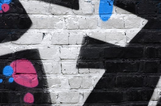 Fragment of graffiti drawings. The old wall decorated with paint stains in the style of street art culture. Colored background texture photo