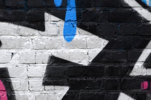 Fragment of graffiti drawings. The old wall decorated with paint stains in the style of street art culture. Colored background texture photo