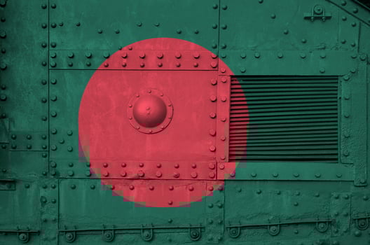 Bangladesh flag depicted on side part of military armored tank closeup. Army forces conceptual background photo
