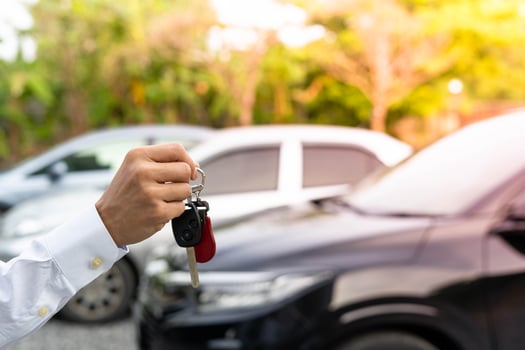 selling car, car sale, deal concept The dealer gives the car keys to the new owner or renter with an insurance contract. photo