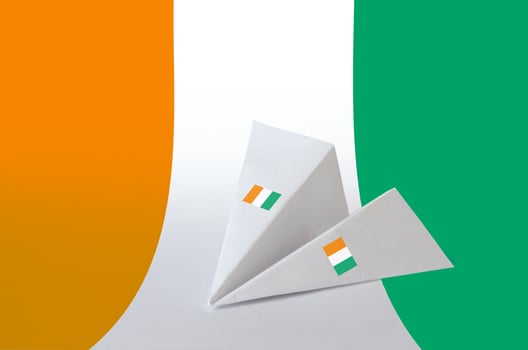 Ivory Coast flag depicted on paper origami airplane. Handmade arts concept photo