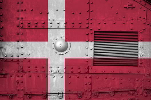 Denmark flag depicted on side part of military armored tank closeup. Army forces conceptual background photo