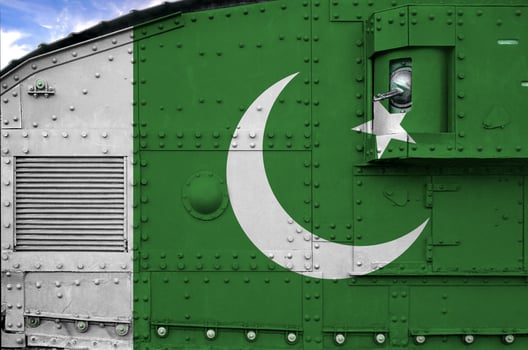 Pakistan flag depicted on side part of military armored tank closeup. Army forces conceptual background photo