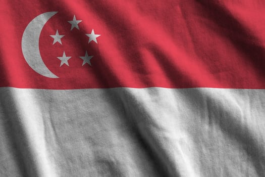 Singapore flag with big folds waving close up under the studio light indoors. The official symbols and colors in banner photo