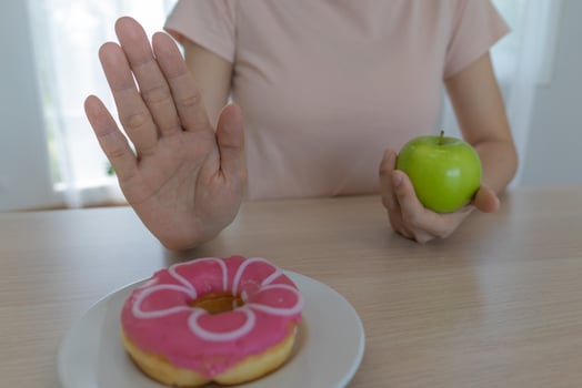slim body Women choose during healthy foods and junk food, female choose green apple for diet. Good healthy food. weight lose, balance, control, reduce fat, low calories, routines, exercise. photo