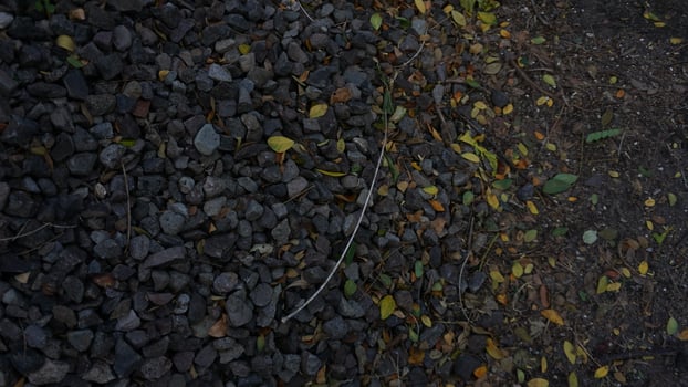A fire hydrant is sitting on a gravel road photo