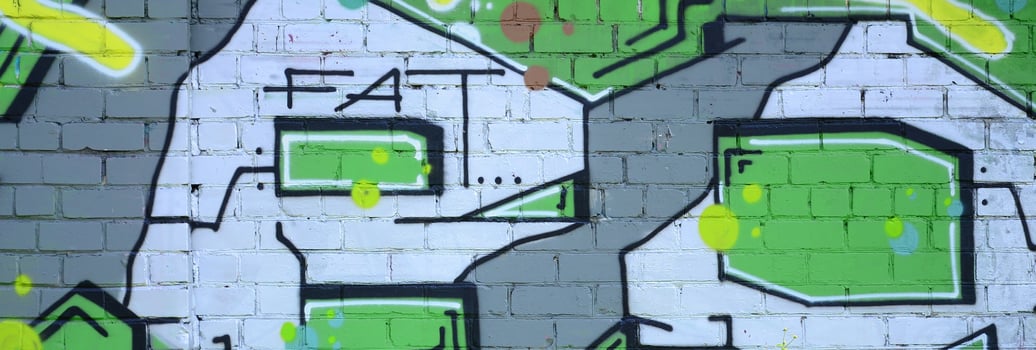 Fragment of graffiti drawings. The old wall decorated with paint stains in the style of street art culture. Colored background texture in green tones photo