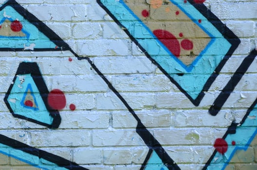 Fragment of graffiti drawings. The old wall decorated with paint stains in the style of street art culture. Colored background texture in cold tones photo