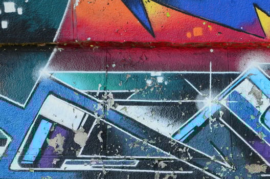 Fragment of graffiti drawings. The old wall decorated with paint stains in the style of street art culture. Multicolored background texture photo