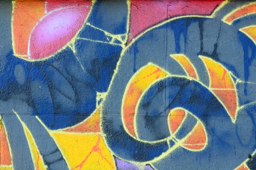 Fragment of graffiti drawings. The old wall decorated with paint stains in the style of street art culture. Multicolored background texture photo