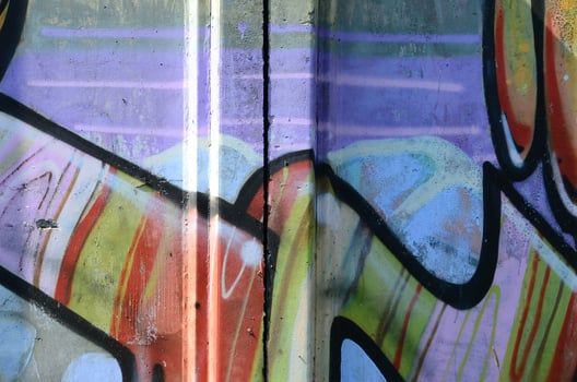 Fragment of graffiti drawings. The old wall decorated with paint stains in the style of street art culture. Multicolored background texture photo