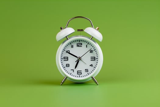 Alarm clock on green background, time concept, clock photo