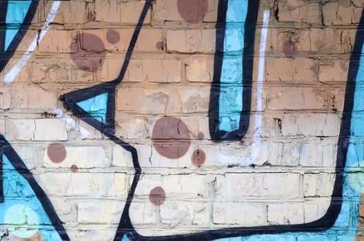 Fragment of graffiti drawings. The old wall decorated with paint stains in the style of street art culture. Colored background texture photo