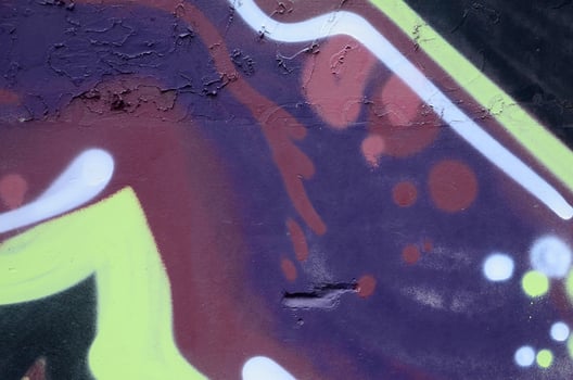 Fragment of graffiti drawings. The old wall decorated with paint stains in the style of street art culture. Colored background texture photo