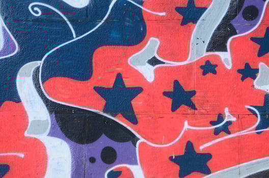Fragment of graffiti drawings. The old wall decorated with paint stains in the style of street art culture. Colored background texture in cold tones photo