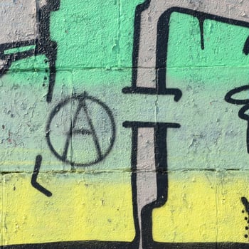 Fragment of graffiti drawings. The old wall decorated with paint stains in the style of street art culture. Colored background texture in green tones photo