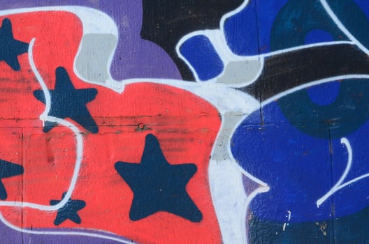 Fragment of graffiti drawings. The old wall decorated with paint stains in the style of street art culture. Colored background texture in cold tones photo