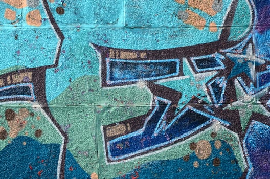 Fragment of graffiti drawings. The old wall decorated with paint stains in the style of street art culture. Colored background texture in cold tones photo