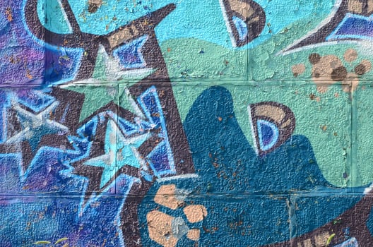 Fragment of graffiti drawings. The old wall decorated with paint stains in the style of street art culture. Colored background texture in cold tones photo