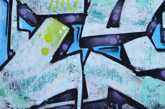 Fragment of graffiti drawings. The old wall decorated with paint stains in the style of street art culture. Colored background texture in cold tones photo