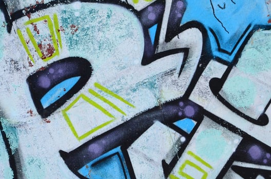 Fragment of graffiti drawings. The old wall decorated with paint stains in the style of street art culture. Colored background texture in cold tones photo
