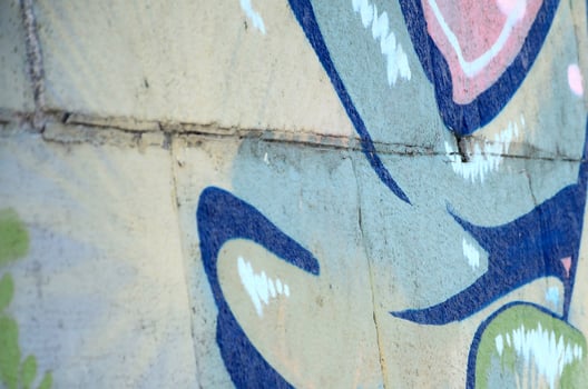Fragment of graffiti drawings. The old wall decorated with paint stains in the style of street art culture. Colored background texture in green tones photo