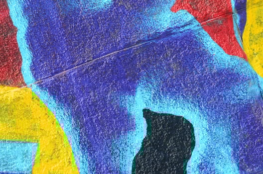 Fragment of graffiti drawings. The old wall decorated with paint stains in the style of street art culture. Multicolored background texture photo