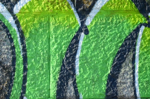 Fragment of graffiti drawings. The old wall decorated with paint stains in the style of street art culture. Colored background texture in green tones photo