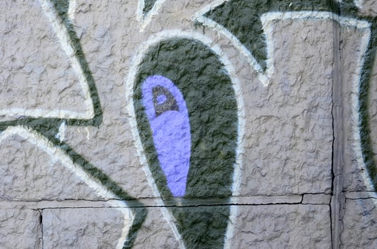 Fragment of graffiti drawings. The old wall decorated with paint stains in the style of street art culture. Colored background texture in purple tones photo