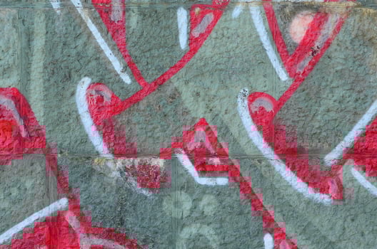 Fragment of graffiti drawings. The old wall decorated with paint stains in the style of street art culture. Colored background texture in warm tones photo