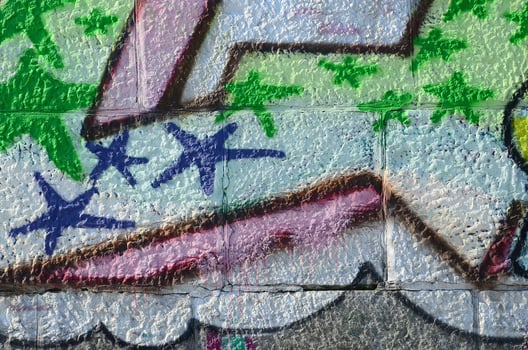 Fragment of graffiti drawings. The old wall decorated with paint stains in the style of street art culture. Colored background texture in green tones photo