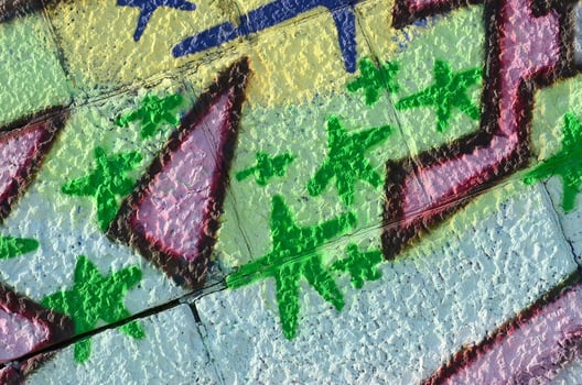 Fragment of graffiti drawings. The old wall decorated with paint stains in the style of street art culture. Colored background texture in green tones photo